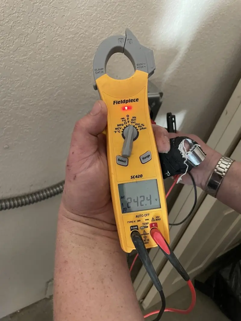Voltage testing with clamp meter during Electrical Installation Services in Fortville